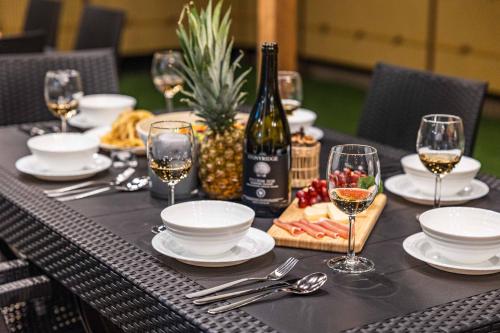 a table with a bottle of wine and wine glasses at PEACE OF REST TAKASHIMA in Takashima