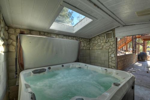 a bath tub in a room with a window at 050 - The Great Escape - Meredith Lodging in Big Bear City