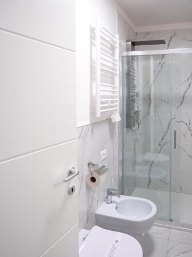 a bathroom with a toilet and a shower and a sink at Alto Apartment in Rome