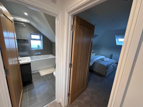 a bathroom with a bed and a sink and a tub at Abingdon in Sunningwell