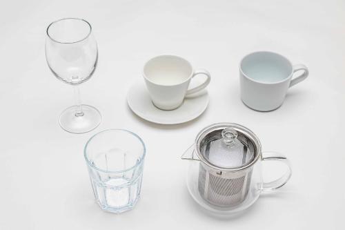 a table with two glasses and a cup and a pitcher at PEACE OF REST TAKASHIMA in Takashima