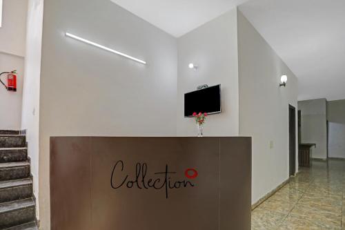 a lobby with a sign on the wall and a television at Collection O Naveen Stay in Gurgaon