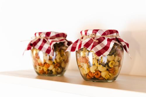 two vases with food in them sitting on a shelf at Mos Country House in Tremosine Sul Garda