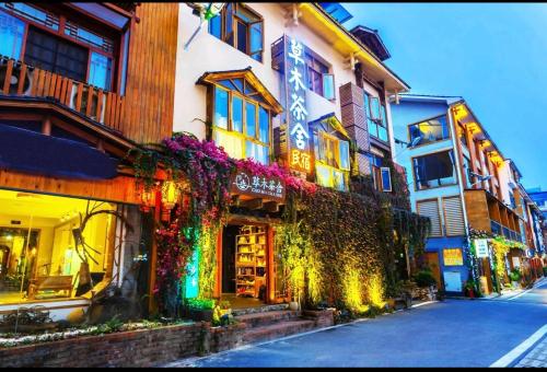 um edifício com flores ao lado de uma rua em Tea House em Zhangjiajie