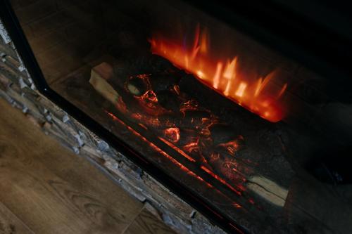 an open oven with fire inside of it at Luxury Chalet Kajmer in Jurgów