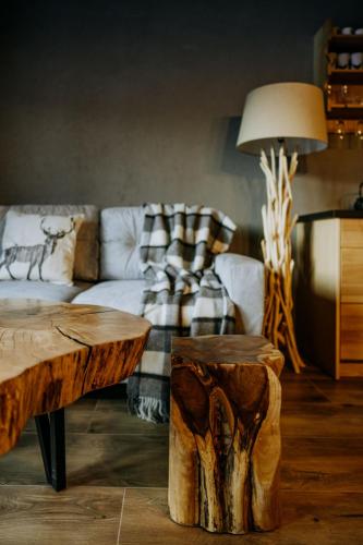 a living room with a couch and a table at Luxury Chalet Kajmer in Jurgów