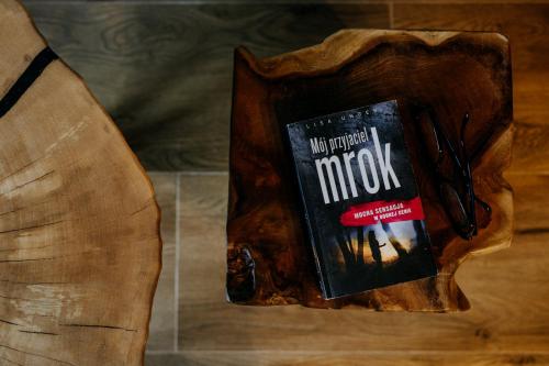 a book sitting on top of a wooden table at Luxury Chalet Kajmer in Jurgów