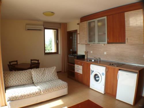 a living room with a couch and a washing machine at Nessebar View Apartament in Nesebar