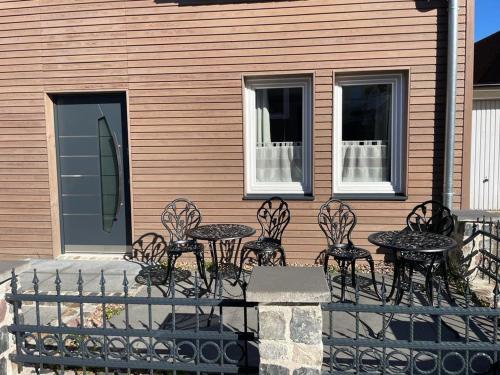 a group of chairs and tables in front of a house at Haus Boutique in Bad Salzuflen