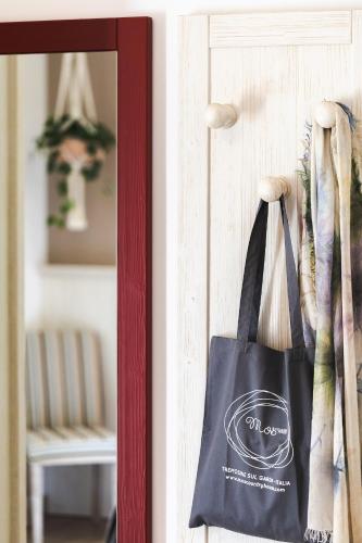 a bag hanging on a door in front of a mirror at Mos Country House in Tremosine Sul Garda
