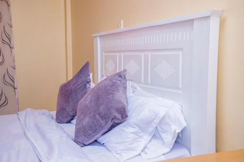 מיטה או מיטות בחדר ב-Elnara Suites