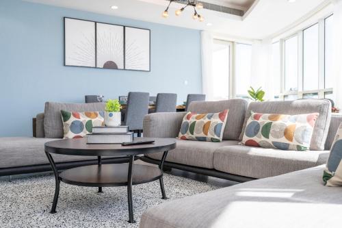 a living room with a couch and a table at Heaven Crest Vacation Homes Dubai Marina - 4 Bedroom Suite with Marina View near JBR Beach, Free Parking, Wi-Fi, Gym and Pool in Dubai