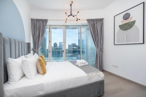 a bedroom with a bed and a large window at Heaven Crest Vacation Homes Dubai Marina - 4 Bedroom Suite with Marina View near JBR Beach, Free Parking, Wi-Fi, Gym and Pool in Dubai