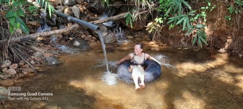 a man sitting on an elephant in the water at Sinharaja Vini Villa in Deniyaya