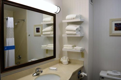 a bathroom with a sink and a mirror and towels at Comfort Inn, Cleveland South - Richfield in Richfield