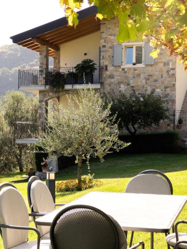 a table and chairs in front of a house at Mos Country House in Tremosine Sul Garda