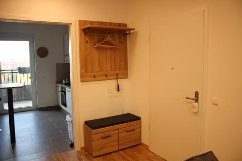 a kitchen with a wooden cabinet and a door at Zentrum Residenz - Wohnen auf höchstem Niveau in Leipzig