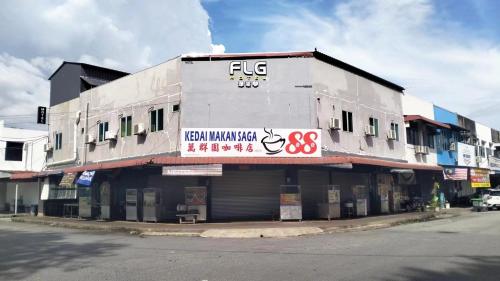 a white building with a sign on the side of it at FLG Motel in Alor Setar