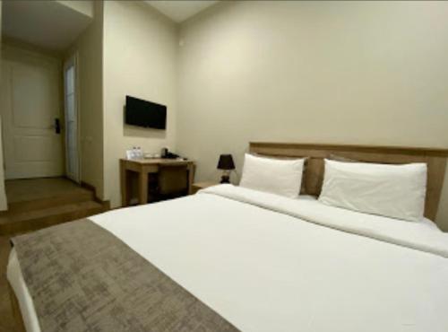 a hotel room with two beds and a television at Access Hotel in Baku