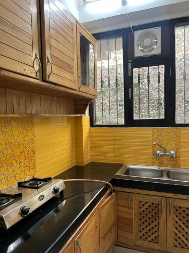 a kitchen with a stove and a sink in it at Panoramic View of Lake close to Mall Road - Oasis in Nainital