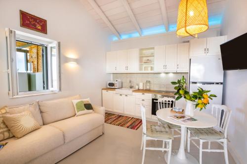 a living room with a couch and a table at Valandou Guesthouses in Karpathos Town