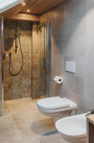 a bathroom with a toilet and a shower at Residence Obermoarhof - Family Apartments with Pool & Playground in Vandoies