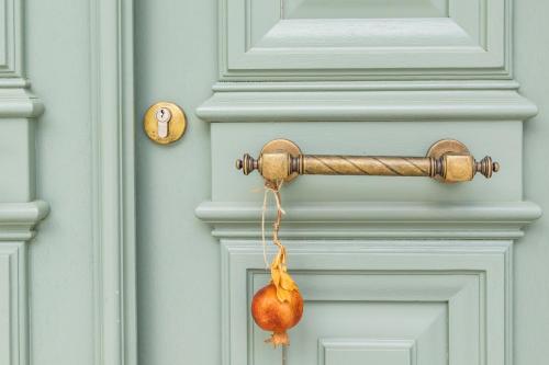 a door with a dried onion hanging from it at Valandou Guesthouses in Karpathos Town