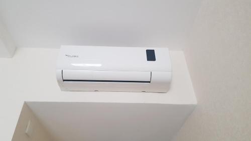 a white printer sitting on top of a white drawer at Access Hotel in Baku
