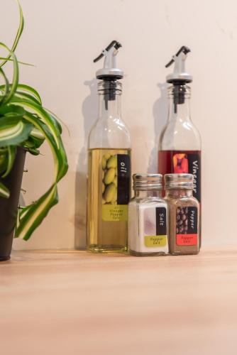 three bottles of olive oil and jars of pickles at NIEUW De Grenspaal ZUID 2slpk - 4P - SAUNA - LAADPAAL in Riemst