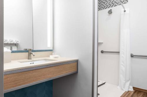a bathroom with a sink and a shower at Hilton Garden Inn West Palm Beach Airport in West Palm Beach