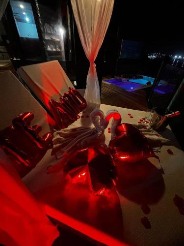 a table with two red bleeding swans on it at Pousada Vista Grega in Arraial do Cabo