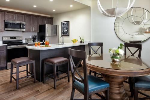 a kitchen with a large island with a table and chairs at Hyatt Vacation Club at Coconut Cove in Bonita Shores