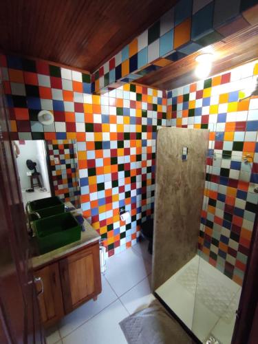a bathroom with multicolored tiles on the wall at Apartamento na Passarela in Porto Seguro