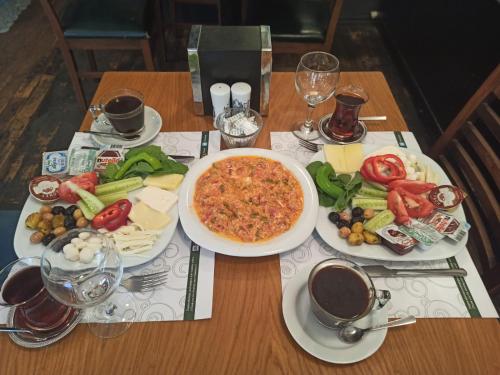 - une table avec des assiettes de nourriture et une pizza dans l'établissement Magnova Studios, à Istanbul