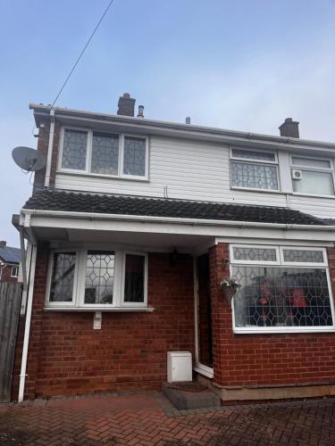 a red brick house with white windows on it at No name 