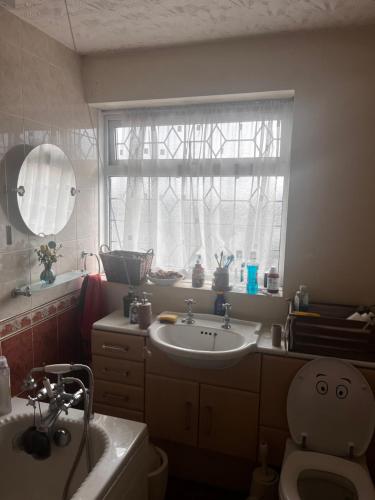 a bathroom with a sink and a toilet and a window at No name 