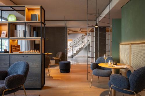 a restaurant with a table and chairs and a staircase at Hotel Maier in Friedrichshafen