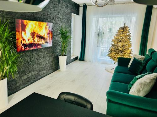 a living room with a fireplace and a christmas tree at Aici te simți ca acasa 2 in Iaşi
