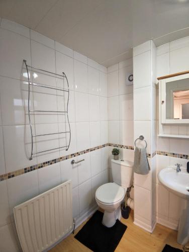 a white bathroom with a toilet and a sink at A&A Luxury Stay Eldon Street in Pallion