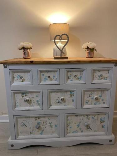 a dresser with a lamp on top of it at The Old Sack Warehouse in Hereford