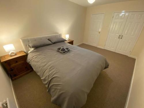 a bedroom with a large bed with two white doors at The Old Sack Warehouse in Hereford