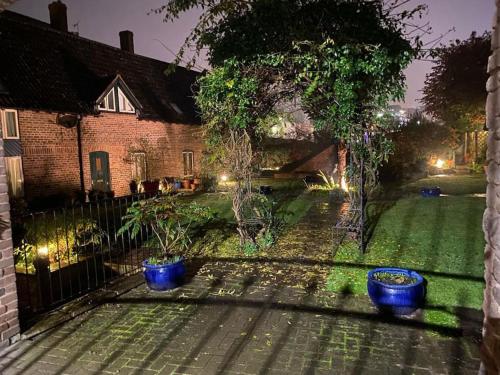 two blue pots sitting in the yard of a house at The Old Sack Warehouse in Hereford