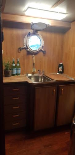 a kitchen with a sink and a mirror on the wall at M/S Furusund in Furusund