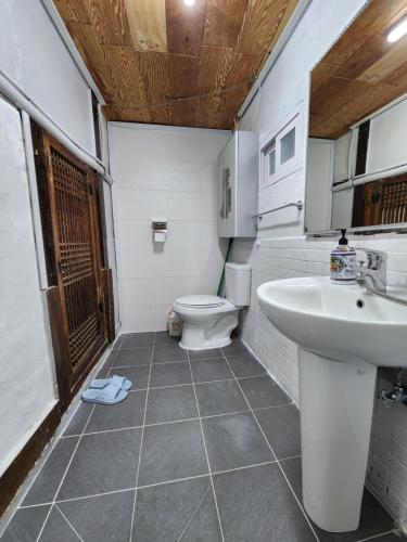 a bathroom with a toilet and a sink at Kims House Andong in Andong