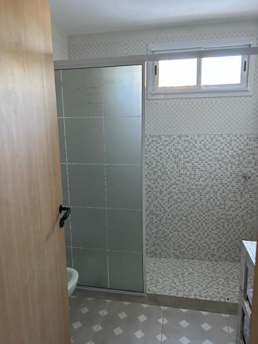 a bathroom with a shower with a glass door at Apart Gallery - San Lorenzo - Salta in Salta