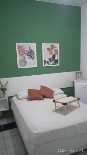 a bedroom with a bed with a table on it at Hospedaria FOR755 in Fortaleza