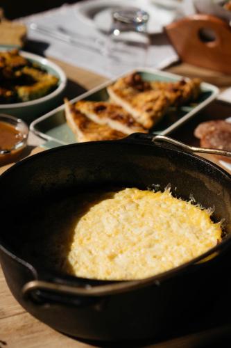 a pan filled with food on a table at Τα Πέτρινα της Ελάτης - Petrina Elatis in Elati Trikalon
