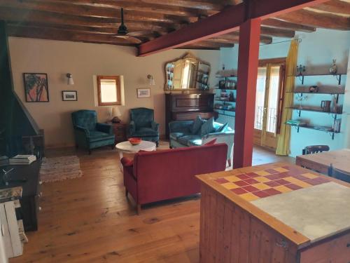 a living room with a couch and a table at Can Penjarella II in Arbúcies