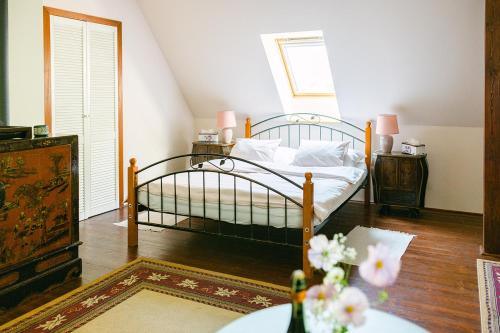 a bedroom with a bed and a table with flowers at Penzion Na Staré Poště in Nymburk