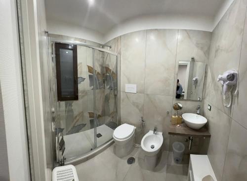 uma casa de banho com um chuveiro, um WC e um lavatório. em Casa Auri em Nápoles